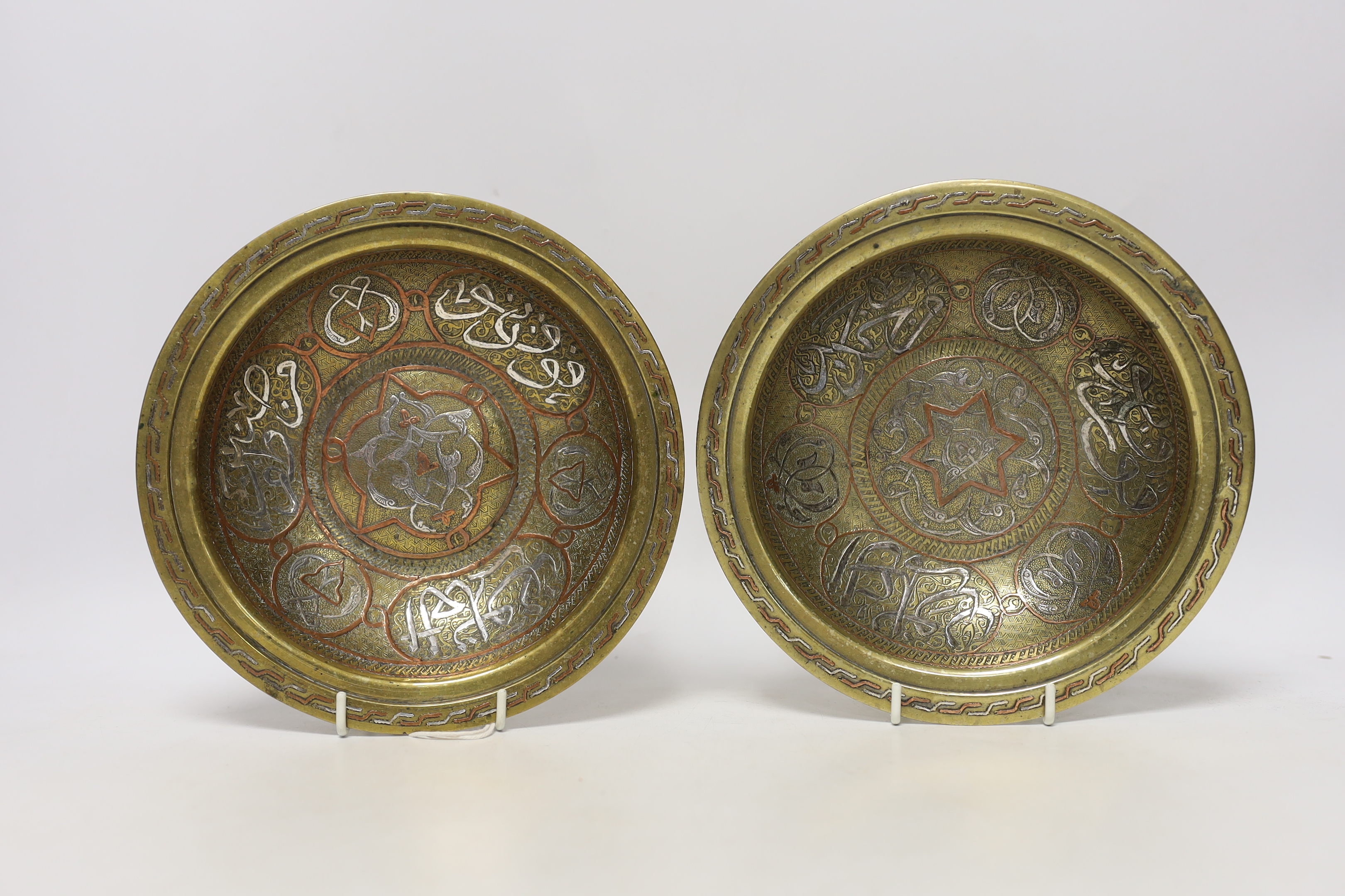 A pair and another inlaid brass dishes, Cairo ware, largest 19cm